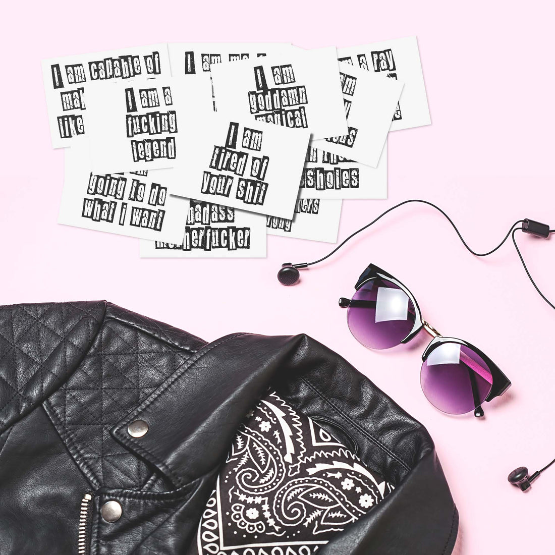 Sweary Affirmation Cards Lying next to a leather jacket and sunglasses